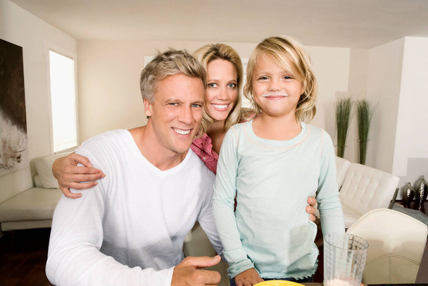 portrait of happy family sitting on sofa at home - Photo, image
