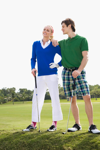 portrait of a young couple with a golf ball - Fotó, kép