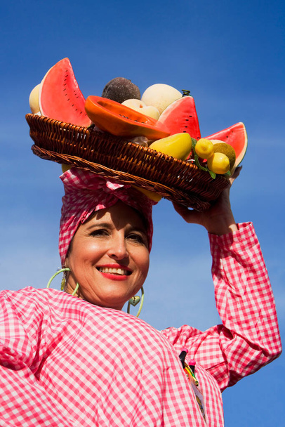 portrait of a woman with a basket of fruits - Φωτογραφία, εικόνα