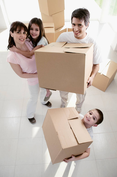 happy family with boxes and cardboard box - Valokuva, kuva