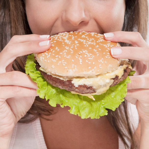 woman with hamburger and burger - Foto, Imagen