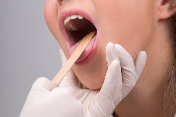 woman applying lip gloss on white background - 写真・画像