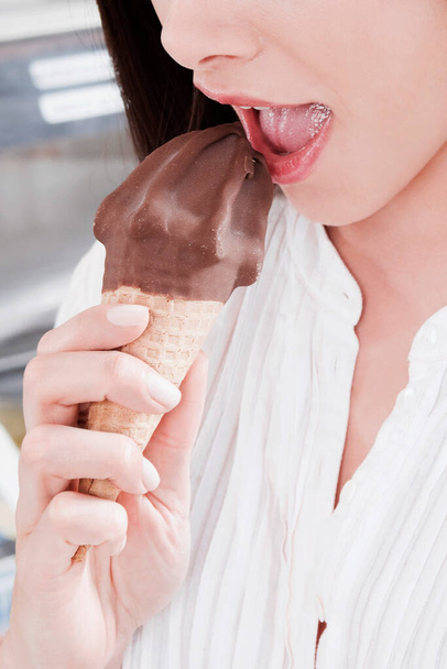 close-up of a young woman eating ice cream - Fotó, kép