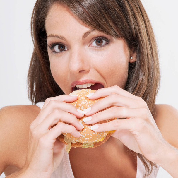 beautiful young woman eating burger - Fotoğraf, Görsel