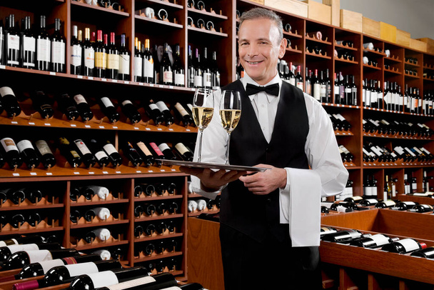sommelier holding wine in a row - Photo, image