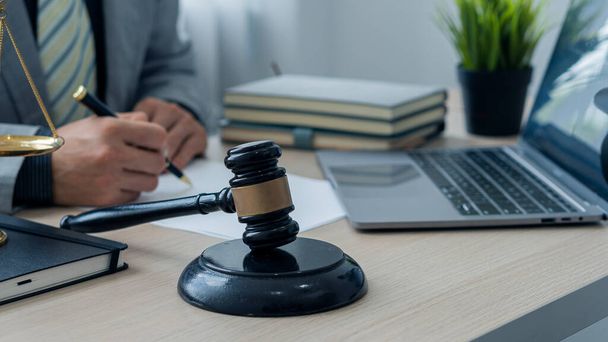 Attorney's Office Judge with hammer and scales with laptop on desk, businessman in suit or lawyer working on paperwork. Law, Guidance and Justice Concepts - Photo, Image