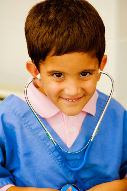 Portrait of a boy listening to his heartbeats with a stethoscope - Φωτογραφία, εικόνα