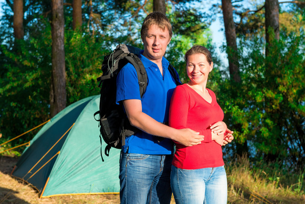 portrait of a beautiful couple next to the tent - Фото, изображение