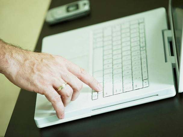 close-up of a man's hand typing on a keyboard - 写真・画像