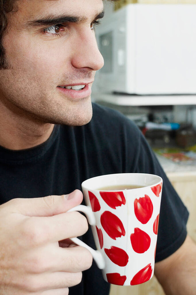 man holding cup of coffee in the morning - 写真・画像