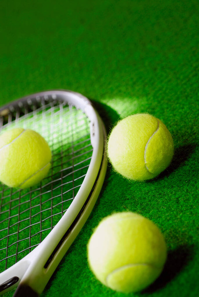 Close-up of three tennis bowls and a tennis racket - Foto, imagen