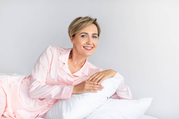 Happy mature woman looking at camera after wake up - Fotografie, Obrázek