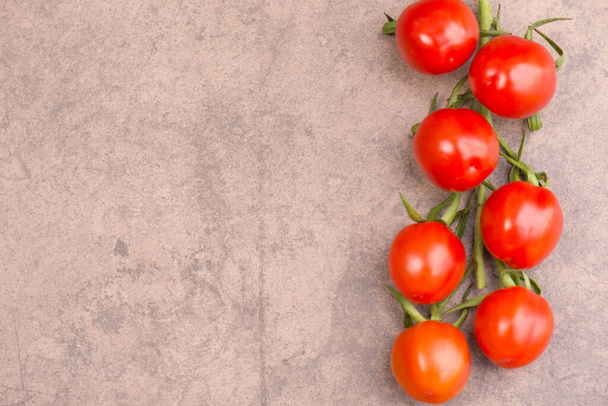 The fresh ripe cherry tomatoes on a brown surface with copy space - Photo, Image