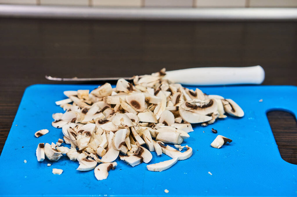 A pile of fresh cut mushrooms on the plastic board - Photo, Image