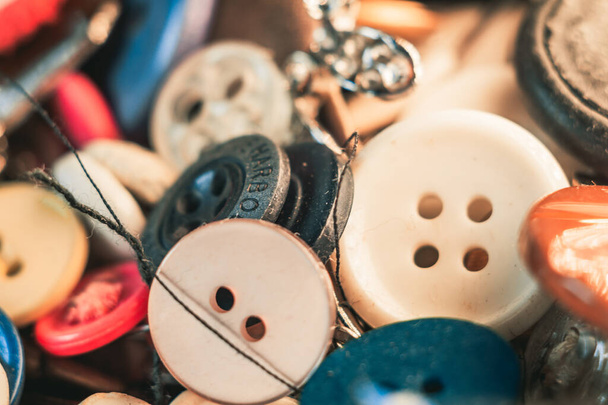 A selective focus shot of a stack of mixed cloth buttons of different color and size - Foto, Imagem