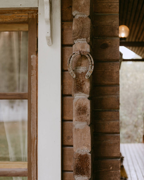 the old horseshoe on the country house wall - Fotó, kép