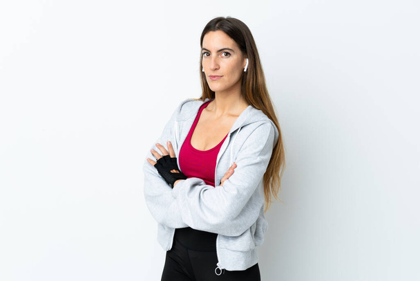 Young sport woman over isolated background keeping the arms crossed - Foto, Imagen