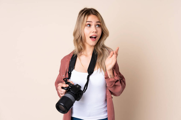 Young photographer girl over isolated background with surprise facial expression - Φωτογραφία, εικόνα