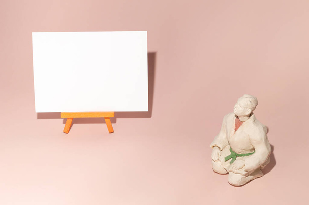 Martial arts teacher setting on pastel background with white canvas. Free space - 写真・画像
