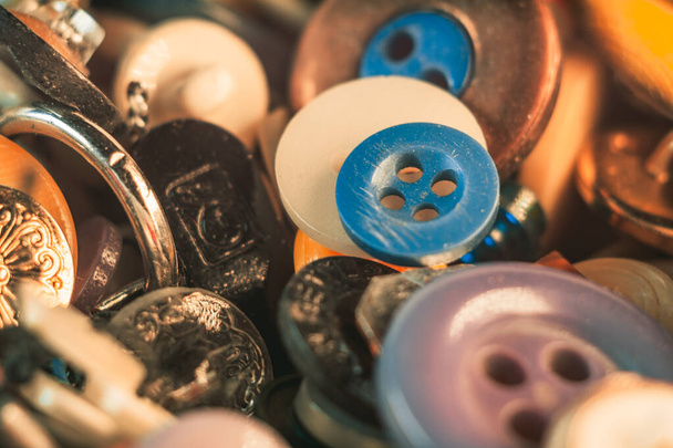 A selective focus shot of a stack of mixed cloth buttons of different color and size - Valokuva, kuva