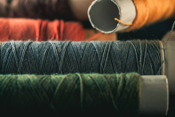A closeup shot of colorful thread stocks piled one on another - Fotoğraf, Görsel