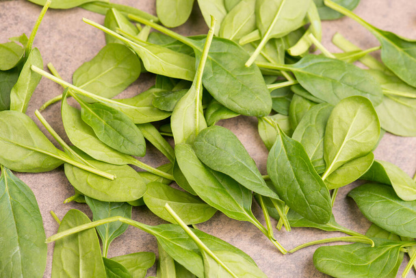A closeup of a heap of fresh green spinach isolated on a white background - Valokuva, kuva