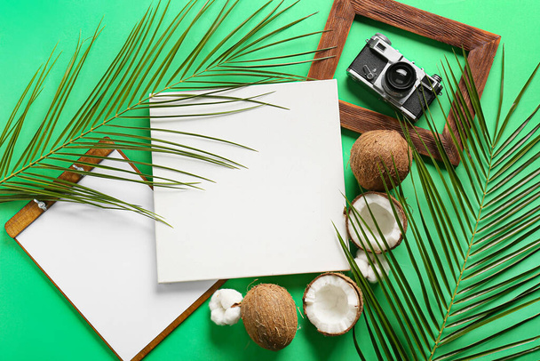 Composition with blank poster, clipboard, coconuts and photo camera on color background - Valokuva, kuva