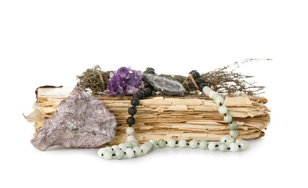 Old book, herbs, Tibetan beads and gemstones on white background - Photo, Image