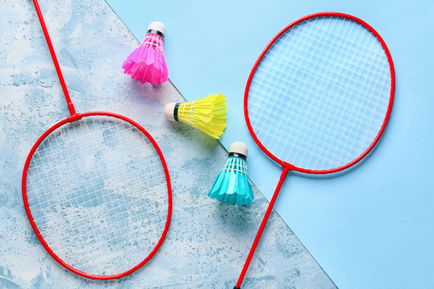 Badminton rackets and shuttlecocks on color background - Fotografie, Obrázek
