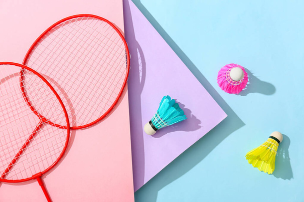 Badminton rackets and shuttlecocks on color background - Photo, Image