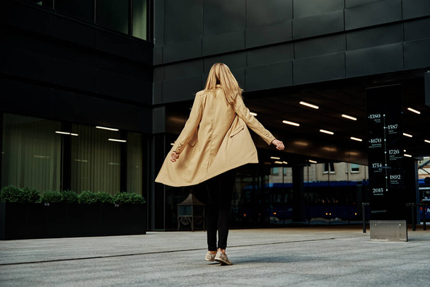 Donna in soprabito cammina a stret di città - Foto, immagini