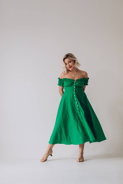 Beautiful woman in a green linen dress  - 写真・画像