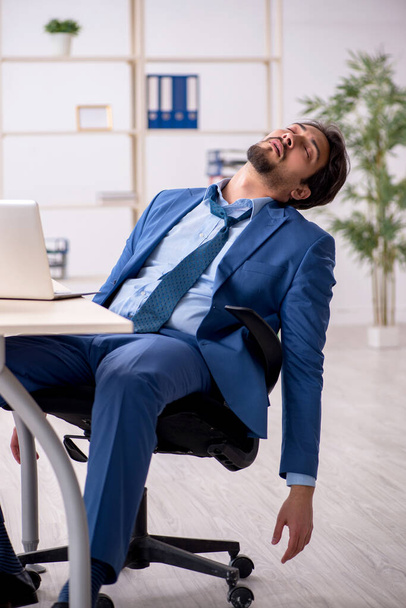 Young male employee and too much work in the office - Φωτογραφία, εικόνα