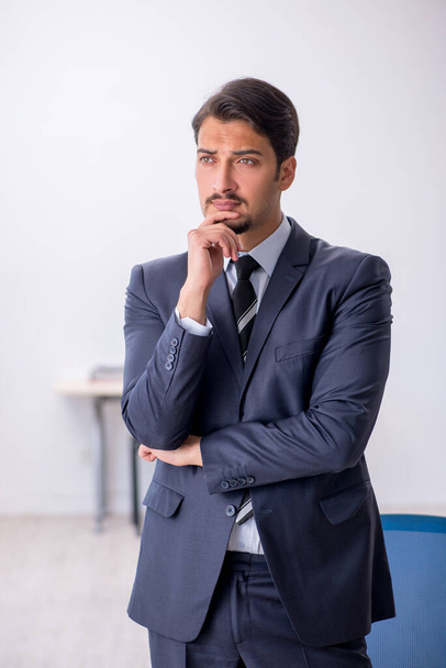 Young male employee sitting at workplace - Фото, зображення