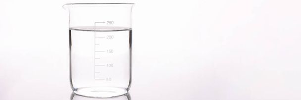 Sterilized water is poured into measuring glass closeup - Fotó, kép