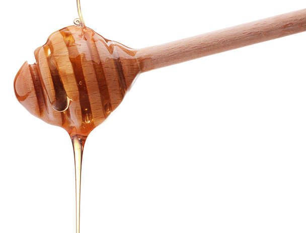 Honey  on wooden   dipper - Foto, afbeelding