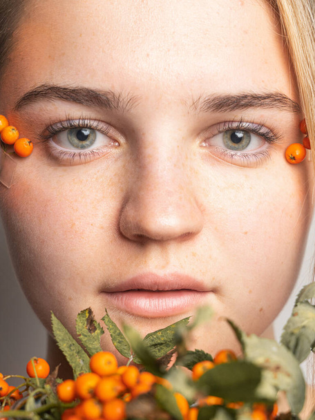 Retrato de uma jovem com sardas decoradas com Rowan em seu rosto. - Foto, Imagem