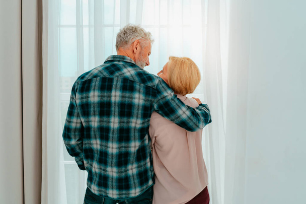 Retired husband and wife hug each other at home - Фото, зображення