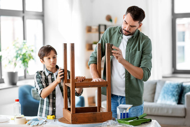 father and son sanding old table with sponge - Фото, изображение