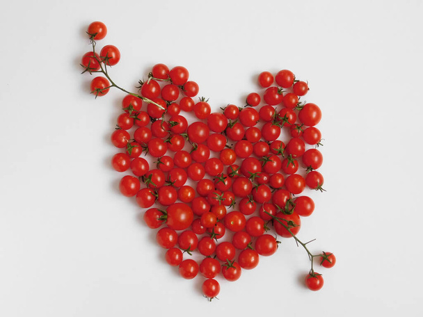 cherry tomatoes on a white background.  tomato heart - Foto, afbeelding
