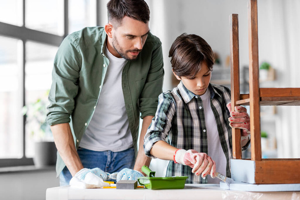 father and son painting old table in grey color - Photo, Image