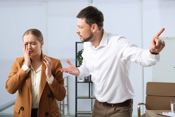 Man scolding woman in office. Toxic work environment - Photo, Image