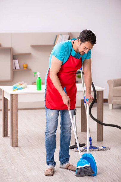 Young male contractor cleaning the house - Photo, image