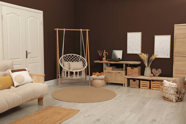 Trendy boho style furniture and decor in living room. Interior design - 写真・画像