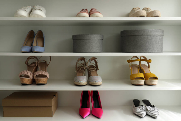 Storage rack with different stylish women's shoes - Foto, Imagem