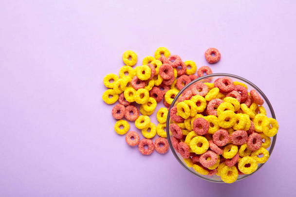Multicolor cereals with fruity on purple background. Blank space for texts. - 写真・画像