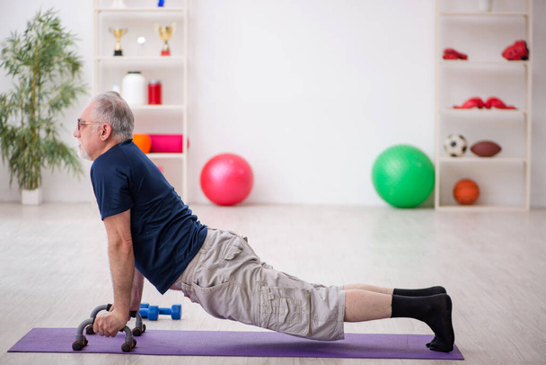 Old man doing sport exercises indoors - Zdjęcie, obraz