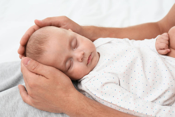 Father holding his cute sleeping baby, closeup - Фото, зображення