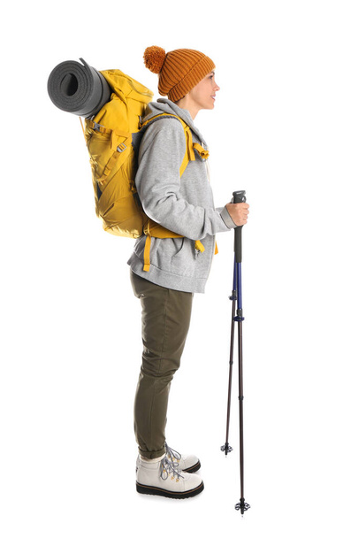 Female hiker with backpack and trekking poles on white background - Фото, изображение