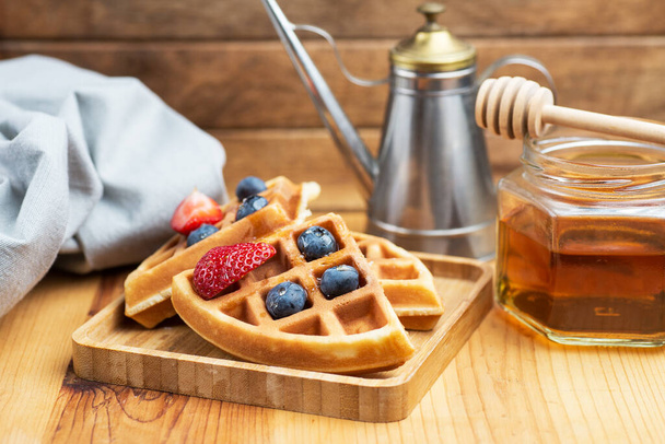 fresh waffles with blueberries and honey for breakfast. close-up - 写真・画像